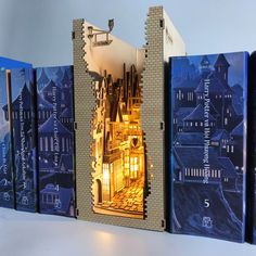 an open book case with some books in front of it on a white table top