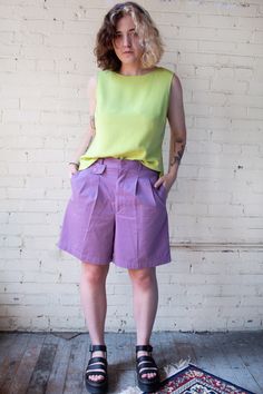 "Fabulous purple high waisted shorts made by 'Baxter and Wells'. Pleated trouser style shorts that fall to the mid thigh. Has three pockets in the front and one in the back. Shorts have an elastic back that gives some flexibility to the waist; zipper and single button closure.  Very good to excellent vintage condition with no stains or flaws of note. Marked women's size 12, see the full measurements below. Please feel free to reach out with any sizing questions that you may have. Measurements (t Retro High-waisted Shorts With Belt Loops, Retro Knee-length Shorts For Summer, Vintage Summer Shorts With Belt Loops, Retro Shorts With Belt Loops, Vintage Belt Loop Shorts For Summer, Retro Relaxed Fit Shorts With Built-in Shorts, Retro Relaxed Fit Short Leg Bottoms, Retro Shorts With Relaxed Fit And Built-in Shorts, Retro Fitted Shorts With Short Leg