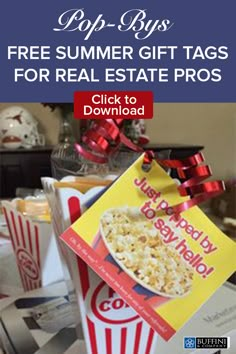 a box of popcorn with a red bow on it sitting on a table next to other boxes