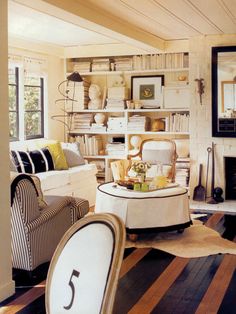 a living room filled with furniture and bookshelves next to a fire hydrant