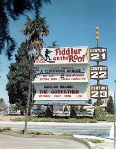 a sign for fiddler on the roof in front of a building with palm trees