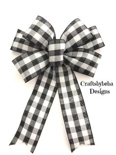 the black and white gingham bow is attached to an iron - on ribbon