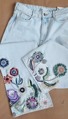 three pieces of embroidered clothing sitting next to each other