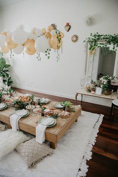 a table set up with plates and food for a party or brunch event