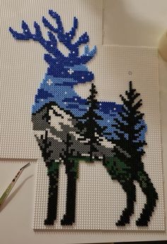 an image of a deer made out of legos with blue and white paint on it