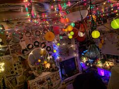 a room filled with lots of lights hanging from the ceiling and decorations on the walls