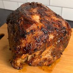 a piece of meat sitting on top of a wooden cutting board