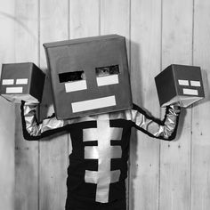 a man in a costume holding two boxes on his head