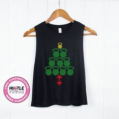 Elevate your holiday workouts with our kettlebell Christmas tree design. This funny tank blends merriment with muscle, offering a uniquely spirited touch to your festive fitness routine. Perfect for those who love holiday workouts, this shirt is a playful Christmas crossfit gift. Whether at the gym or festive gatherings, it's a thoughtful and humorous present for fitness enthusiasts who embrace the season with style. ---------------------------------------------------------- 𝐌𝐨𝐫𝐞 𝐜𝐨𝐥𝐨𝐫 Holiday Workout Shirt, Christmas Gym Shirts, Crossfit Gifts, Christmas Workout, Holiday Workout, Funny Tanks, Funny Holiday, Gym Shirt, Christmas Tree Design