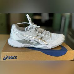 the asics shoe is on top of a box and ready to be used by someone