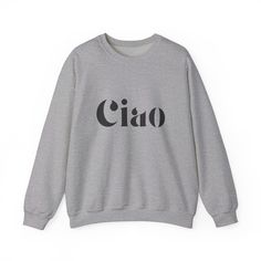 Stay warm and stylish with the Ciao Sweatshirt! The ribbed collar and medium-heavy fabric blend of cotton and polyester provide ultimate coziness. No more itchy side seams, thanks to the tear-away label. Available in sand, gray, or white from Gildan. Made using 100% ethically grown US cotton. Gildan is also a proud member of the US Cotton Trust Protocol ensuring ethical and sustainable means of production. The blank shirt's dyes are OEKO-TEX-certified dyes with low environmental impact. Fabric b Beige Cotton Sweater With Letter Print, Bling Bags, Custom Design Shoes, Bling Shoes, Environmental Impact, Heavy Fabric, No More, Stay Warm, Sweater Top