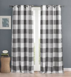 black and white checkered curtains hanging on a window sill in a living room