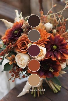 a bridal bouquet with orange, brown and white flowers in it on a wooden table