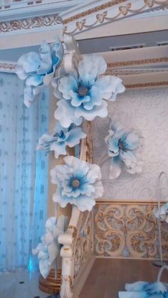 blue flowers are hanging from the ceiling in a room