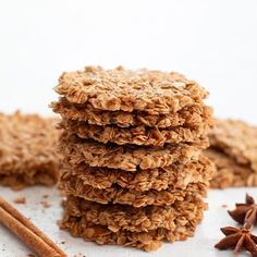 three cookies stacked on top of each other next to cinnamon sticks and star anise