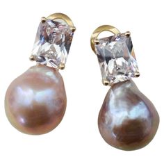 A brilliant pair of pink Kasumi pearls (origin: Japan) are paired with radiant cut white sapphires in these classic drop earrings. Kasumi pearls are famous for their rich colors and metallic finish. They measure 17mm long and along with the sapphires, are set in 18k yellow gold. The earrings have posts with omega clip backs for comfort and security. Luxury High Luster Pear-shaped Pearl Earrings, Luxury Pear-shaped High Luster Pearl Earrings, Sapphire Drop Earrings, Pearl Pink, Radiant Cut, Rich Colors, White Sapphire, Pearl White, Rich Color