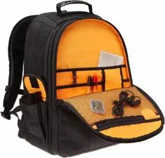 an orange backpack with ear buds and other items in it