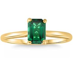 a gold ring with an emerald colored stone