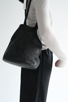 Super soft leather bag. Exterior is soft horse full grain, interior lining is nylon. Interior zip pocket. Adjustable straps so you can modify how you carry the bag. Measures 12" x 10" x 5.5". Made in Italy. Black Shoes Bag, Guidi Handbag, Peter Pan Collar Blouse, Soft Leather Bag, Petal Sleeve, Collar Blouse, Peter Pan Collar, Sleeve Detail, Womens Tote