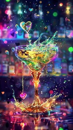 a martini glass filled with liquid on top of a table covered in bubbles and confetti