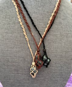 These one of a kind hemp macramé necklaces come in three colors: black, brown and tan, with one emerald stone. The necklace is 12-13 inches in length. None are exactly the same!! When you receive your necklace, it will be prefilled with one Emerald crystal and will arrive safely in a pretty mesh pouch. Also included are crystal care and cleansing instructions along with a crystal properties card. All the Crystals I sell are cleansed, charged & well cared. They're perfect for metaphysical use Earthy Macrame Jewelry With Waxed Cord, Adjustable Macrame Crystal Necklace With Waxed Cord, Handmade Brown Cord Jewelry, Unique Adjustable Brown Crystal Necklace, Unique Brown Adjustable Crystal Necklace, Adjustable Macrame Cord Necklace, Nature-inspired Brown Macrame Necklaces, Macrame Stone Necklace, Male Jewellery