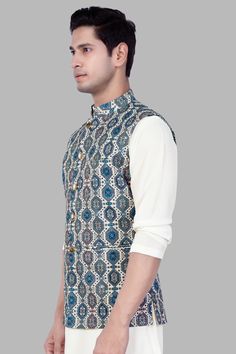 Introducing our stunning Bluish Blue and Claret Red Thread Embroidered Nehru Jacket, a perfect blend of tradition and contemporary style. Ideal for weddings, engagements, or parties, this jacket exudes charm and sophistication. Crafted with meticulous detail, the intricate thread embroidery adds a touch of elegance. Versatile as casual wear, pair it effortlessly with a Kurta Jacket set for a refined ensemble. Elevate your look with this classic Nehru Jacket, a must-have for any fashion-forward m Elegant Blue Bandhgala For Festive Season, Elegant Blue Bandhgala For Festive Occasions, Elegant Blue Festive Bandhgala, Formal Blue Outerwear With Resham Embroidery, Elegant Blue Nehru Jacket With Resham Embroidery, Fitted Blue Nehru Jacket With Chikankari Embroidery, Fitted Blue Nehru Jacket For Designer Wear, Fitted Blue Nehru Jacket For Designer Events, Blue Bollywood Nehru Jacket With Intricate Embroidery