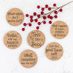 six wine cork coasters that say what table do i move to? and have red berries on them