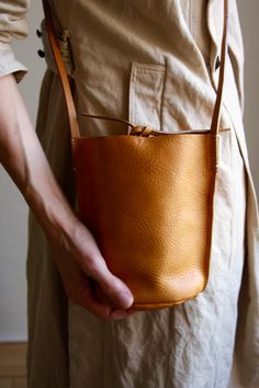 NURAXI by Teresa Robinson — Mini Bucket Bag - Vegetable Tanned Camel Mini Bucket Bag, Mini Bucket Bags, Mini Bucket, Time Zones, Leather Conditioner, Leather Bucket Bag, Mini Crossbody, Travel Companion, Sustainable Design