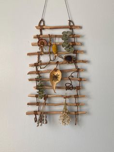 a wall hanging made out of branches and other things on it's side,