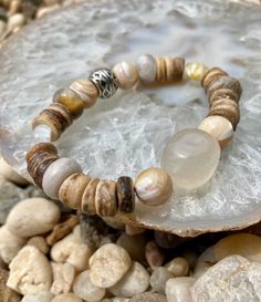 Beautiful light colored beads mixed with wood creates this summery piece ☀️ Bracelet also includes 2 small flower beads. 1 yellow - 1 white  Can be worn alone or stacked  Handcrafted with Love 🐚  Please note: Contains small parts, not recommended for children 0-3. Children over this age should be supervised if wearing. Bohemian Wooden Beads Stretch Bracelet For Beach, Bohemian Brown Stretch Bracelet For Beach, Brown Beaded Bracelets With Natural Stones For Beach, Brown Natural Stones Beaded Bracelets For Beach, Brown Natural Stone Beaded Bracelets For Beach, Handmade Adjustable Beaded Bracelets In Natural Wood, Handmade Adjustable Natural Wood Beaded Bracelets, Spiritual Wooden Beads Bracelets For Beach, Handmade Natural Wood Beaded Bracelets