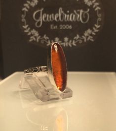 Amber Ring/Natural Baltic Amber Ring. Unique cognac amber and solid silver ring. Handcrafted natural amber ring, set on a beautifully etched floral band. This very versatile organic looking ring is a size 8 1/2, but is perfect on any finger or stacked with all your other silver rings. Custom sizes available, if you don't see your size, just add a note at checkout and I will be happy to make it. . The beautiful natural amber stone measures 25mm or just under one inch. at its longest point. This u Silver Baltic Amber Rings As Gift, Brown Sterling Silver Cabochon Ring, Brown Sterling Silver Ring With Cabochon, Vintage Rings With Natural Inclusions For Gift, Orange Hallmarked Ring As Gift, Handmade Orange Rings For Gifts, Handmade Orange Rings As Gift, Spiritual Orange Rings As Gift, Spiritual Orange Rings For Gift