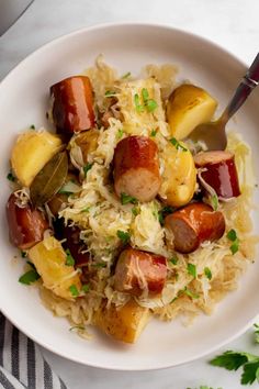 a white bowl filled with rice and sausage