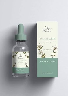 an open bottle of organic jasmin face oil next to a box on a white surface