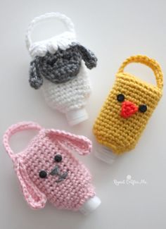 three crocheted items are sitting next to each other on a white surface and one has a plastic bottle in the shape of a dog's head