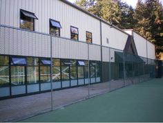 the tennis court is fenced off and ready to be used as a practice area