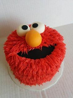 the cake is decorated with red frosting and has an angry face on it's side