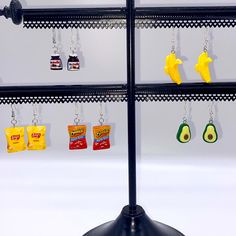 several key chains hanging from the side of a rack with avocados and chips