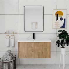 a bathroom with a sink, mirror and towels on the wall next to a potted plant