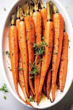 roasted carrots with herbs in a white bowl