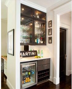 a home bar with wine glasses and liquor bottles