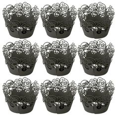 twelve black paper cupcake cases with swirly designs on the top and bottom, set of