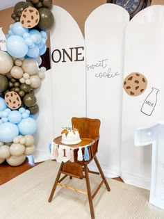 a baby's first birthday party with balloons and cookies