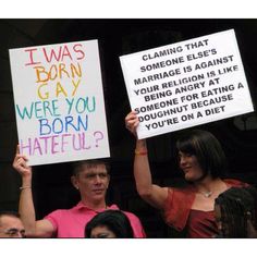 two people holding up signs that say i was born gay and were you born hateful