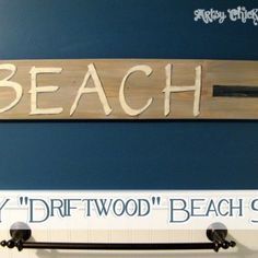 a bathroom with a sign above the toilet and towel bar in front of it that says beach