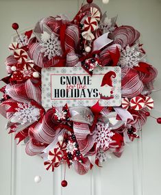 a red and white christmas wreath with some candy canes on it that says gnome for the holidays