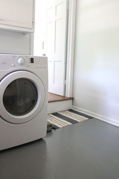 a white washer and dryer in a small room