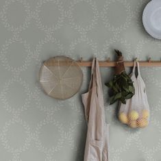 two bags hanging on a wall next to some fruit