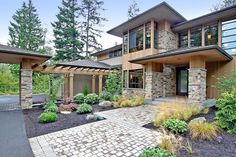 a large house with lots of windows and landscaping