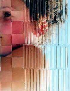 a woman's face is reflected in the glass mosaics on the wall behind her