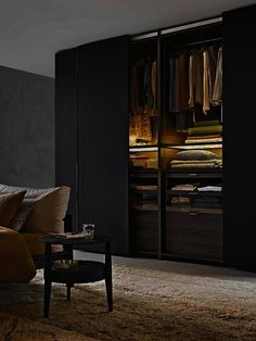 a bedroom with black walls and an open closet